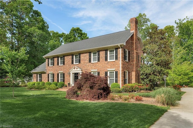 5001 Edinborough Rd, Greensboro, NC 27406 - colonial home featuring a chimney, brick siding, and a front yard