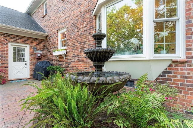 5001 Edinborough Rd, Greensboro, NC 27406 - details with roof with shingles, electric meter, and brick siding