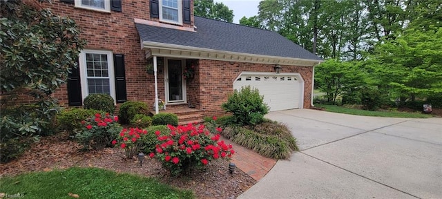 5001 Edinborough Rd, Greensboro, NC 27406 - view of property exterior with concrete driveway, a shingled roof, an attached garage, and brick siding