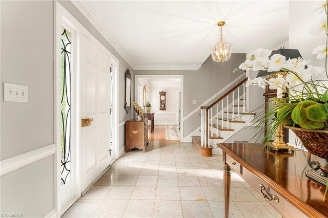 5001 Edinborough Rd, Greensboro, NC 27406 - foyer with a chandelier, stairway, crown molding, and baseboards
