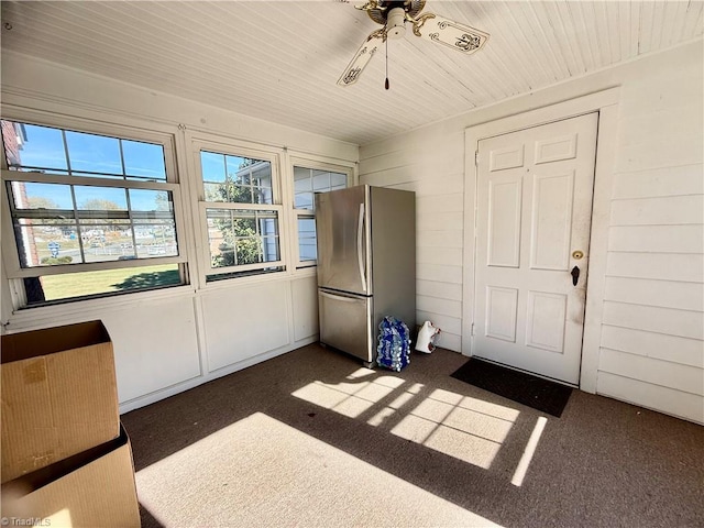 unfurnished sunroom featuring ceiling fan