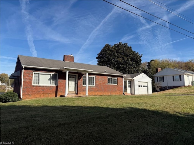 rear view of property with an outbuilding, a garage, and a lawn