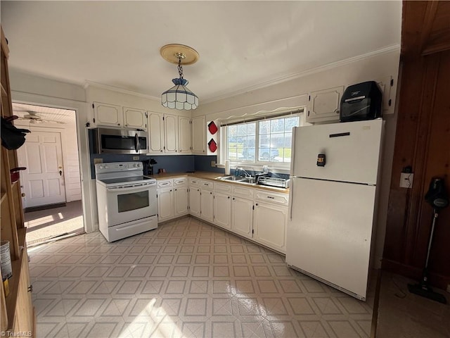 kitchen featuring sink, crown molding, decorative light fixtures, white appliances, and white cabinets