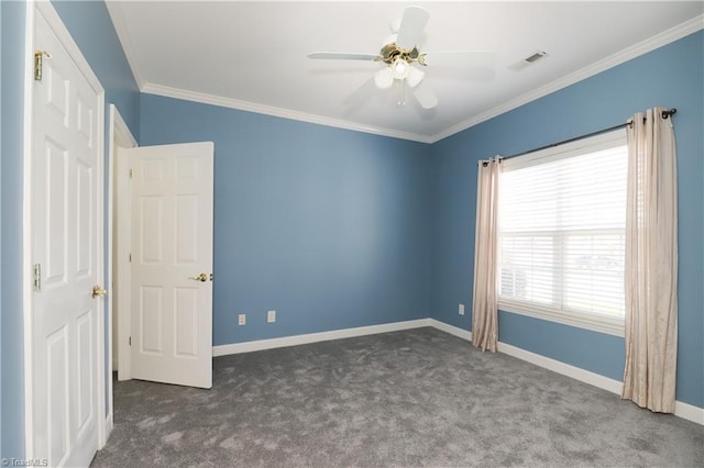 unfurnished bedroom with visible vents, carpet flooring, crown molding, and baseboards