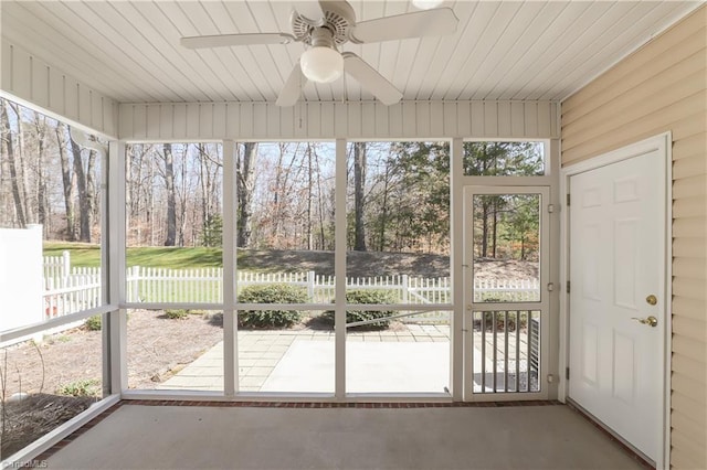 unfurnished sunroom with wood ceiling and ceiling fan