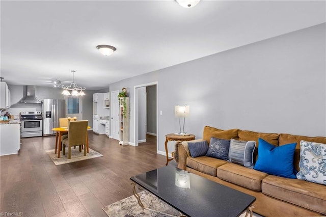 living room featuring a notable chandelier and dark wood-type flooring