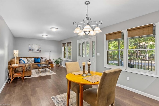 dining space with a chandelier and dark wood-type flooring