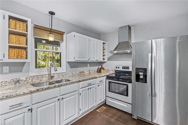 kitchen featuring wall chimney exhaust hood, sink, white cabinetry, and stainless steel appliances