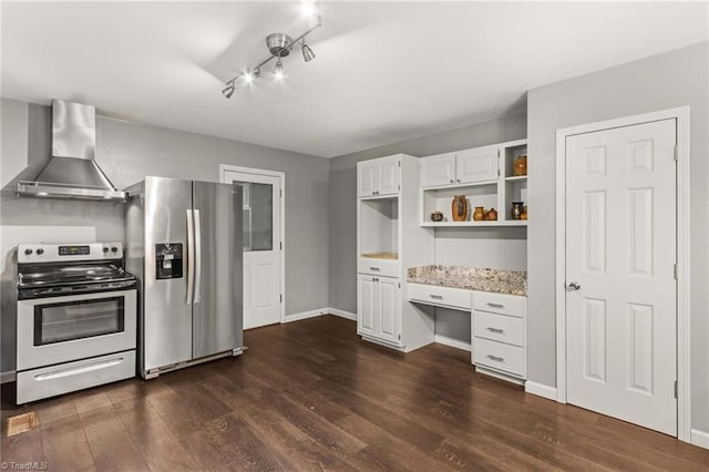 kitchen featuring wall chimney range hood, stainless steel appliances, light stone countertops, white cabinetry, and dark hardwood / wood-style flooring