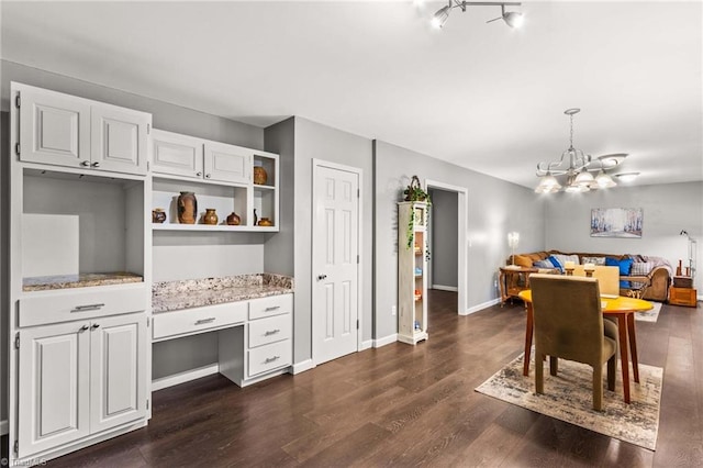 dining space with an inviting chandelier and dark wood-type flooring