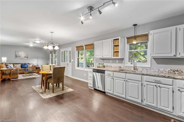 kitchen featuring sink, dishwasher, white cabinetry, and hanging light fixtures