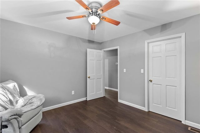 unfurnished room featuring ceiling fan and dark hardwood / wood-style flooring