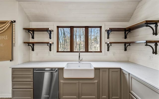 kitchen with vaulted ceiling, dishwasher, and sink