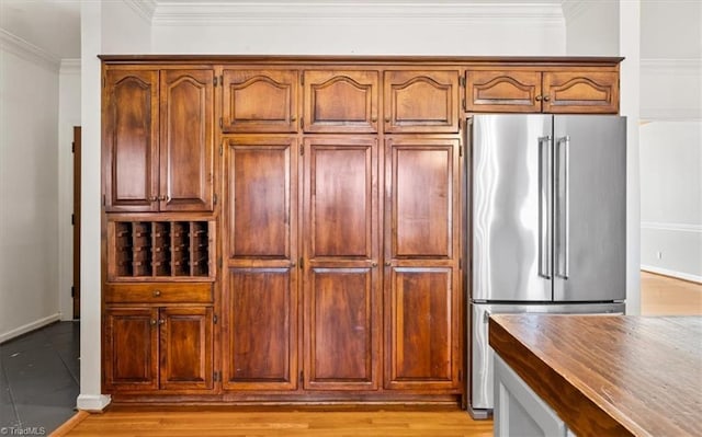 kitchen featuring high quality fridge and ornamental molding