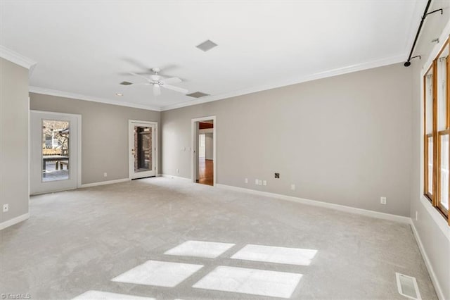 empty room with ceiling fan, light colored carpet, and crown molding