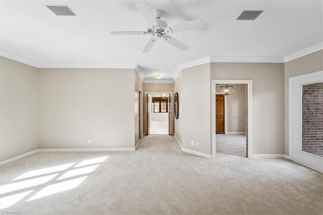 empty room featuring light carpet, ceiling fan, and crown molding