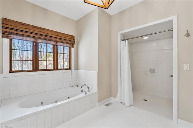 bathroom with tile patterned floors and independent shower and bath