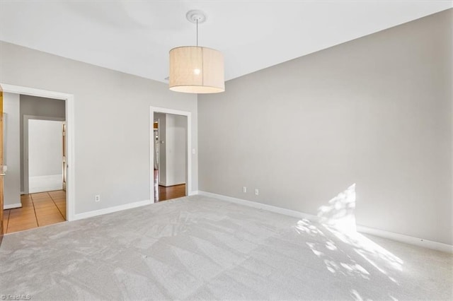 unfurnished bedroom featuring light carpet