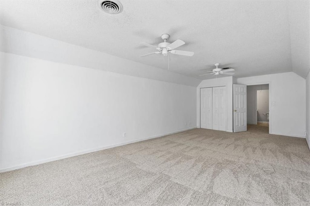 bonus room featuring a textured ceiling, ceiling fan, carpet, and lofted ceiling