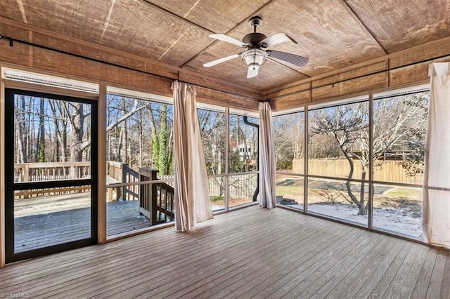 unfurnished sunroom featuring ceiling fan and wood ceiling