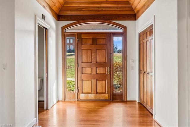 foyer entrance with vaulted ceiling, wooden ceiling, and light hardwood / wood-style flooring