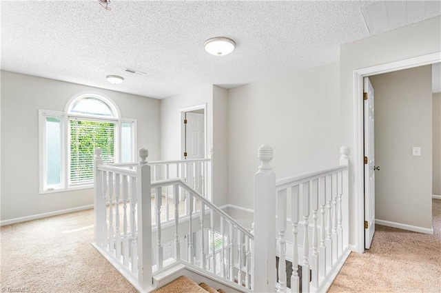 1556 Jubilee Trl, Kernersville, NC 27284 - corridor featuring an upstairs landing, carpet, and a textured ceiling