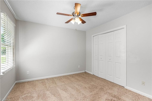 1556 Jubilee Trl, Kernersville, NC 27284 - unfurnished bedroom featuring carpet floors, a closet, a textured ceiling, and ceiling fan
