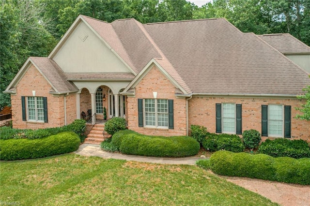 2809 Churchill Ct, High Point, NC 27262 - view of front of home featuring brick siding, roof with shingles, and a front yard