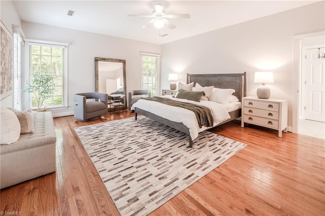 2809 Churchill Ct, High Point, NC 27262 - bedroom with light wood-style floors, multiple windows, ceiling fan, and baseboards