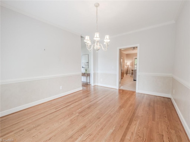 2809 Churchill Ct, High Point, NC 27262 - spare room featuring a chandelier, light wood-style flooring, crown molding, and baseboards