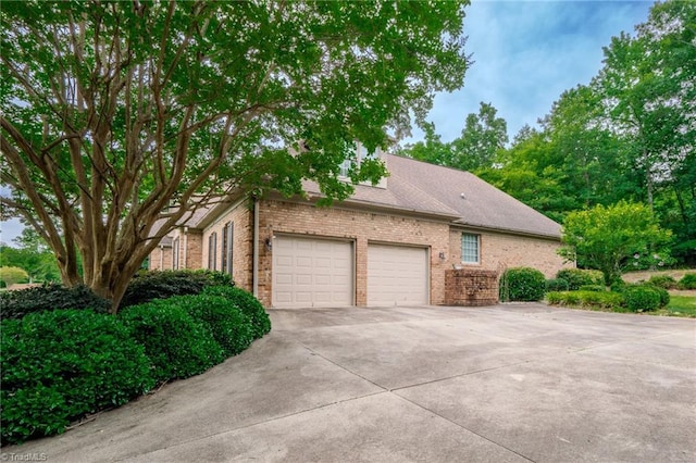 2809 Churchill Ct, High Point, NC 27262 - view of side of property with an attached garage, concrete driveway, and brick siding