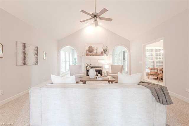 2809 Churchill Ct, High Point, NC 27262 - living room featuring carpet flooring, a ceiling fan, vaulted ceiling, a tile fireplace, and baseboards