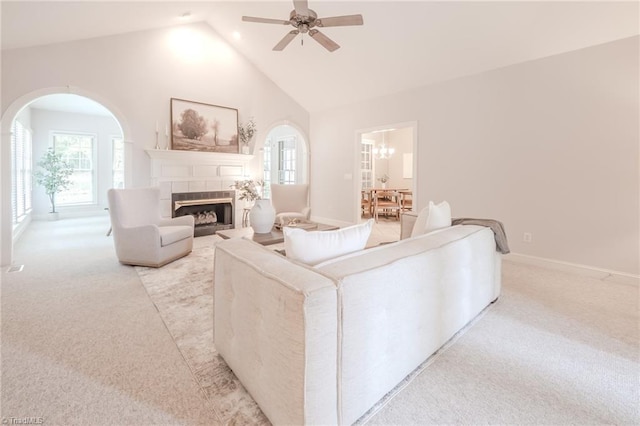 2809 Churchill Ct, High Point, NC 27262 - living room featuring light colored carpet, a fireplace, arched walkways, ceiling fan, and high vaulted ceiling
