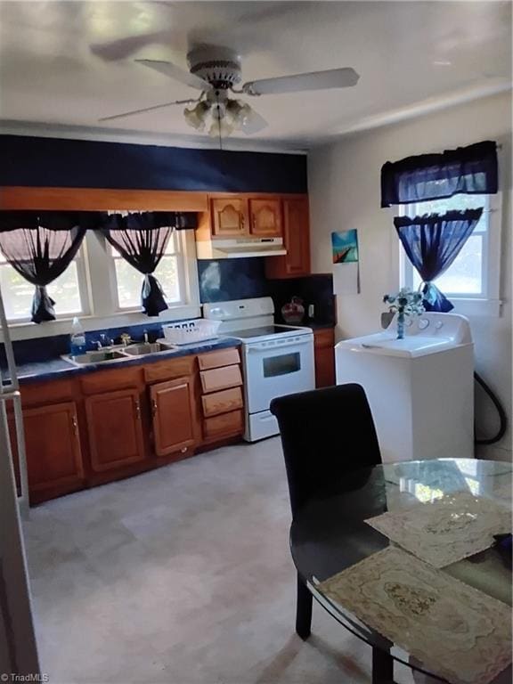 kitchen featuring ceiling fan, white range with electric cooktop, a wealth of natural light, and sink