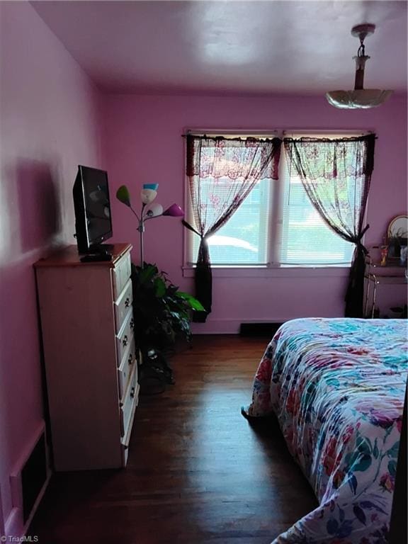 bedroom featuring dark hardwood / wood-style flooring