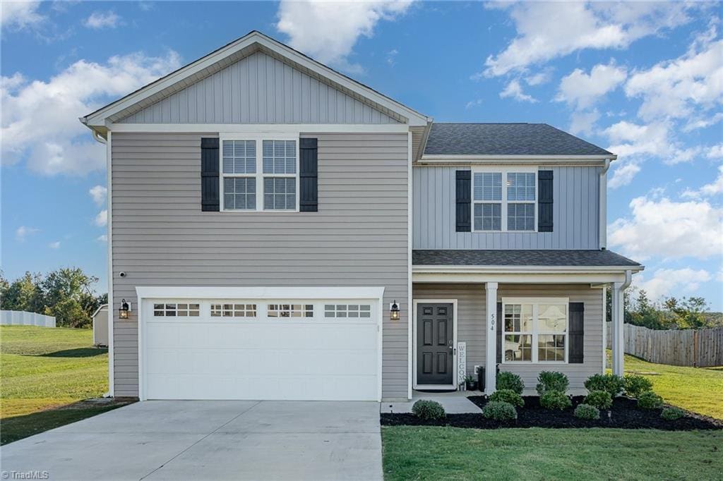 view of front of house with a garage and a front yard