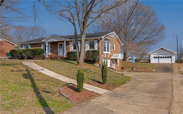 view of front of house with a garage, an outbuilding, and a front lawn