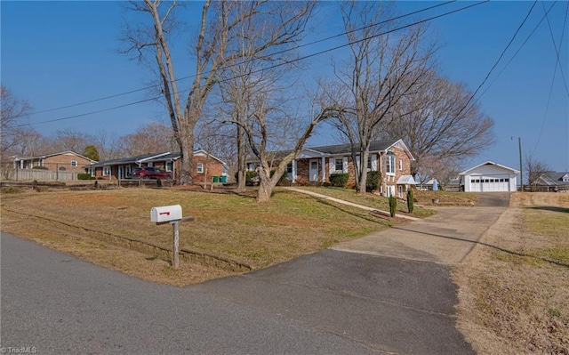 view of front of house with an outbuilding, a garage, and a front yard