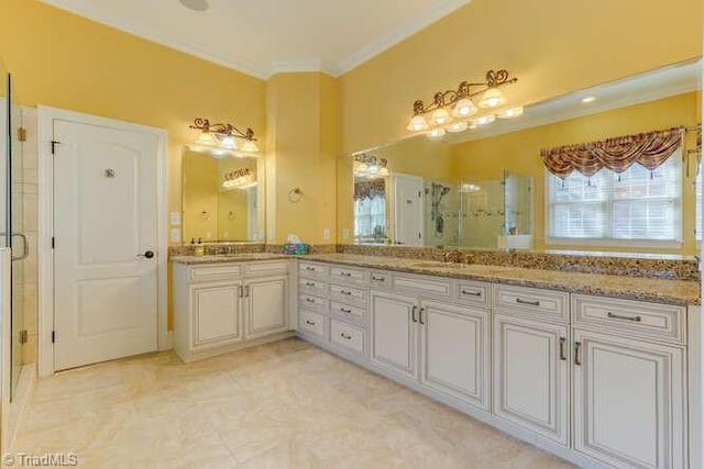 full bathroom featuring vanity, a stall shower, and crown molding