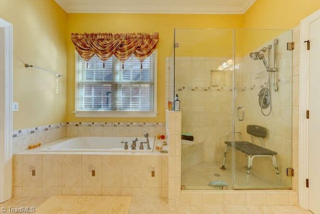 bathroom featuring a garden tub, a shower stall, and crown molding