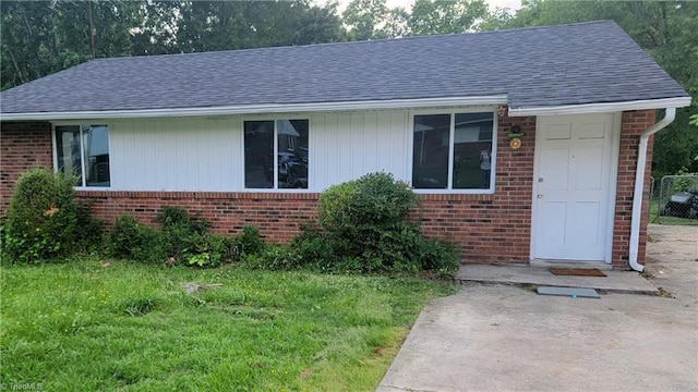 2410 Madre Pl, Greensboro, NC 27406 - single story home with brick siding, a shingled roof, and a front yard