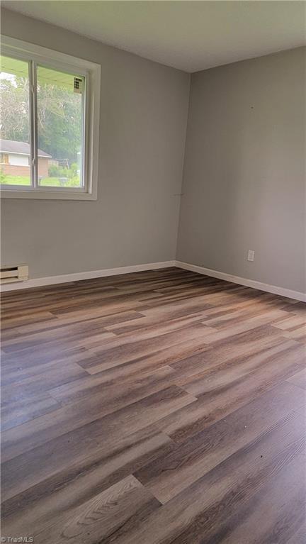 2410 Madre Pl, Greensboro, NC 27406 - empty room with baseboards and wood finished floors