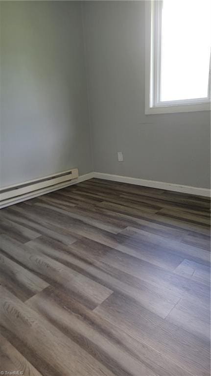 2410 Madre Pl, Greensboro, NC 27406 - spare room featuring wood finished floors, baseboards, and baseboard heating