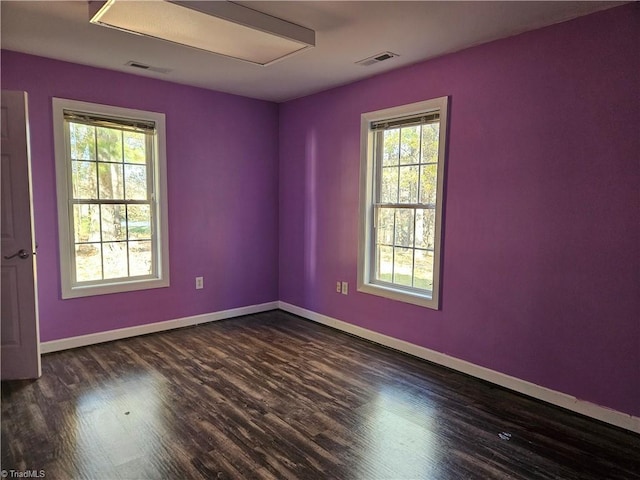 empty room featuring dark hardwood / wood-style flooring