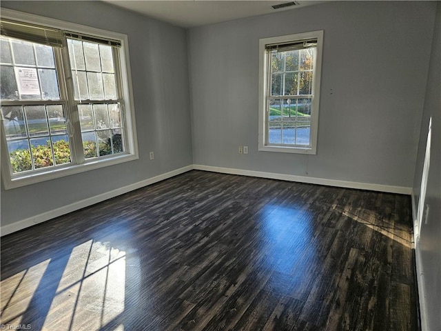 spare room with dark hardwood / wood-style flooring