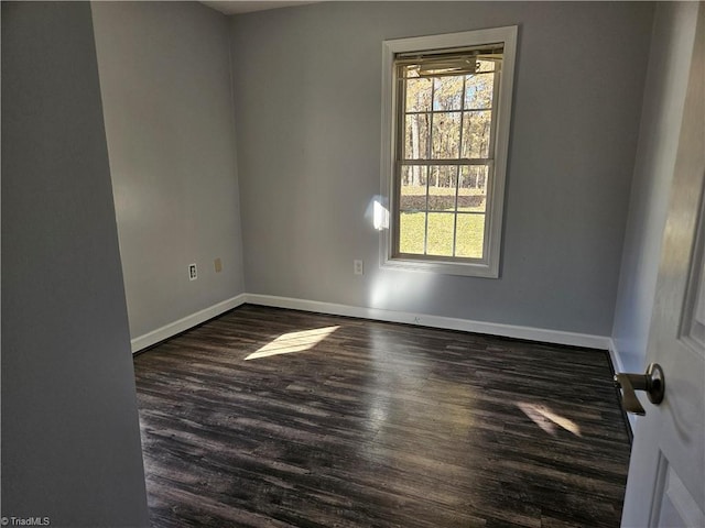 spare room with dark hardwood / wood-style flooring