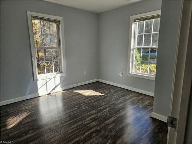 unfurnished room featuring dark hardwood / wood-style flooring