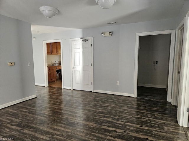 spare room featuring dark wood-type flooring