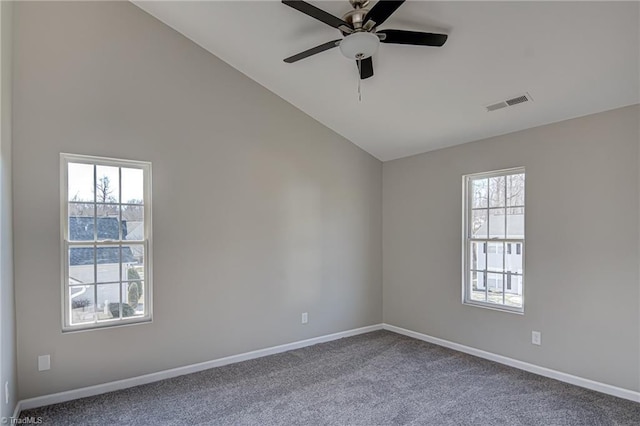 carpeted spare room with ceiling fan and vaulted ceiling