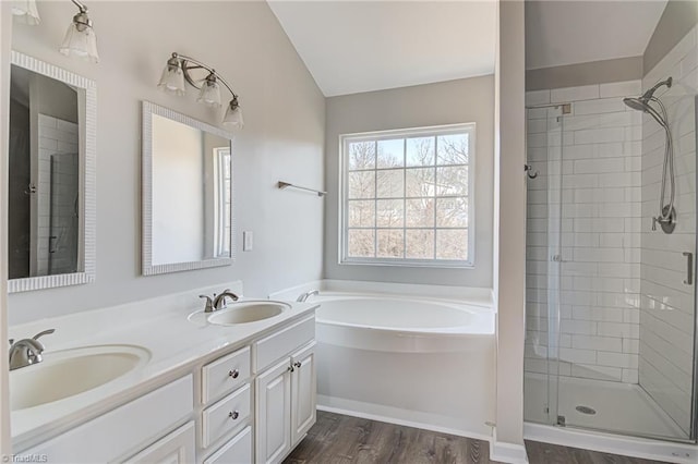 bathroom featuring hardwood / wood-style floors, vanity, independent shower and bath, and lofted ceiling